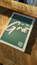 A turquoise and white print that reads "Up the Grá".